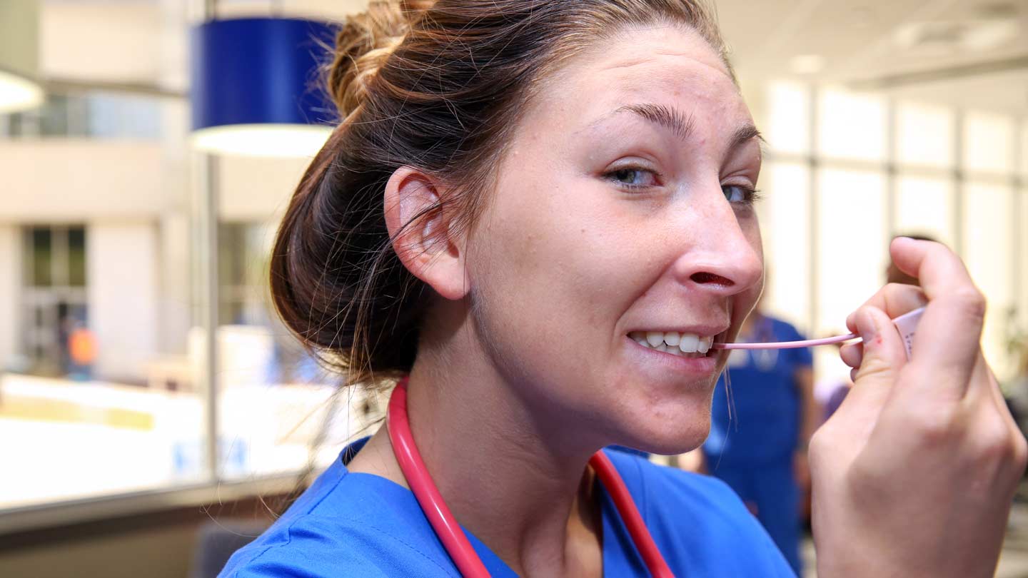 Female nurse with swab in mouth