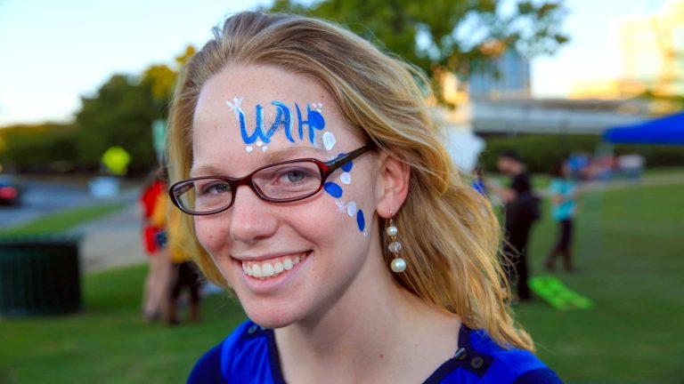 Portrait of blonde woman wearing glasses with facepaint